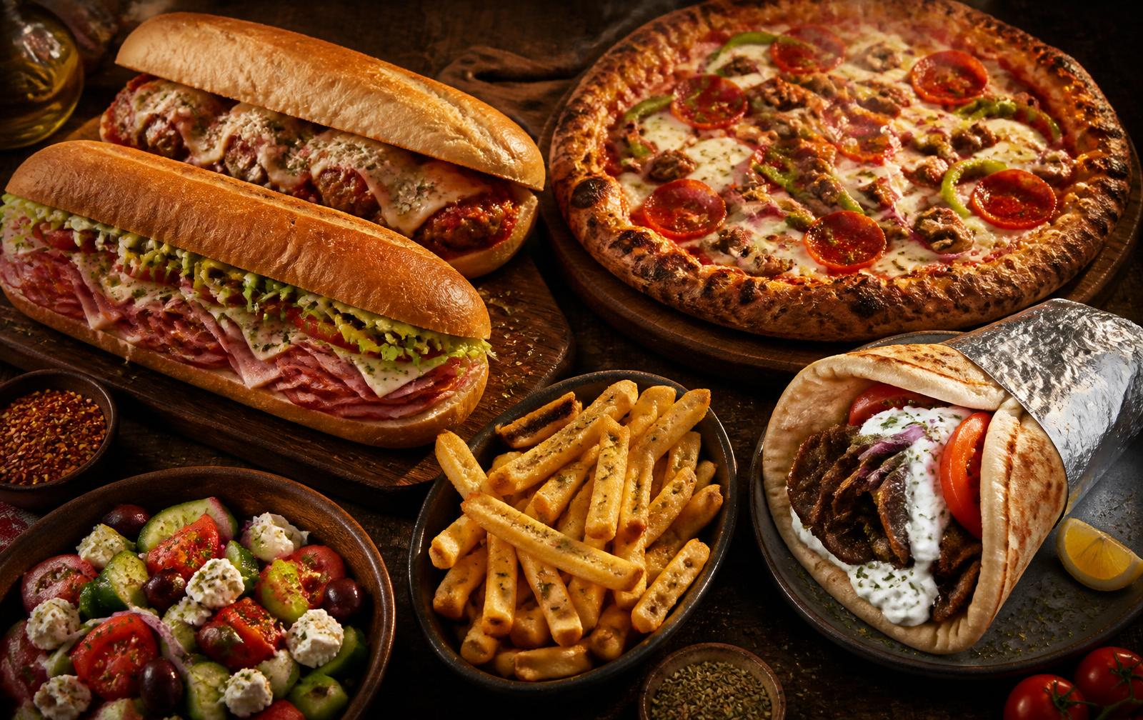 A spread of subs, pizza, gyros and fries from Maria D's